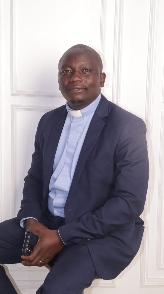 Portrait Pastor Navy Suit Seated Pose Side